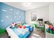 Whimsical bedroom with Mario themed bedding, desk and blue paneling at 5333 Coral Reef Way, Bradenton, FL 34211