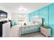 Bright bedroom with blue accent wall, light-colored furniture, and carpeted floor at 5333 Coral Reef Way, Bradenton, FL 34211