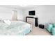 Bright bedroom with blue accent wall, light-colored furniture, and carpeted floor at 5333 Coral Reef Way, Bradenton, FL 34211
