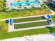 Overhead view of bocce ball court with blue shelters in a manicured sports lawn at 5333 Coral Reef Way, Bradenton, FL 34211