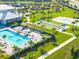 Aerial view of the bocce ball court and pool, surrounded by palm trees and lush landscaping at 5333 Coral Reef Way, Bradenton, FL 34211