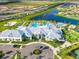 Aerial view of the community clubhouse featuring a large pool and splash pad surrounded by lush landscaping at 5333 Coral Reef Way, Bradenton, FL 34211