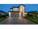 Stately two-story home with a well-maintained front yard, a gray three-car garage and a driveway with pavers at 5333 Coral Reef Way, Bradenton, FL 34211