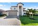Beautiful two-story home featuring a well-manicured lawn, a paved driveway, and a neutral color scheme at 5333 Coral Reef Way, Bradenton, FL 34211