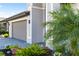 Attached two car garage with neutral door color and clean landscaping with shrubs and colorful flowers at 5333 Coral Reef Way, Bradenton, FL 34211