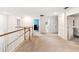 Upstairs landing featuring carpeted floors, white walls, and wood railing leading to the lower level at 5333 Coral Reef Way, Bradenton, FL 34211