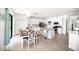 Open kitchen and dining area featuring a modern island, stainless steel appliances, and access to the dining area at 5333 Coral Reef Way, Bradenton, FL 34211