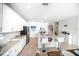 Bright kitchen featuring a center island with seating, white cabinetry, and stainless steel appliances at 5333 Coral Reef Way, Bradenton, FL 34211