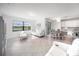 Open concept living and dining area featuring tile floors, white furnishings, and a view of the water at 5333 Coral Reef Way, Bradenton, FL 34211