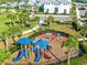 Aerial view of the community playground featuring slides and swings, surrounded by lush landscaping at 5333 Coral Reef Way, Bradenton, FL 34211