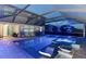 Inviting screened-in pool area featuring a pool, a spa, comfortable seating, and scenic views, ideal for relaxation at 5333 Coral Reef Way, Bradenton, FL 34211