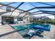 Lovely screened-in pool with spa, chaise lounges, and patio seating ideal for entertaining and relaxation at 5333 Coral Reef Way, Bradenton, FL 34211