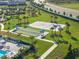 Aerial view of sand volleyball court and bocce ball courts surrounded by mature landscaping at 5333 Coral Reef Way, Bradenton, FL 34211