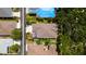 Birds-eye view of a home with a screened lanai, manicured backyard, surrounded by lush greenery and neighboring houses at 553 Meadow Sweet Cir, Osprey, FL 34229