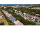 An elevated view of a densely populated residential neighborhood interspersed with trees and glimpses of a distant body of water at 553 Meadow Sweet Cir, Osprey, FL 34229
