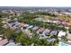 Wide aerial shot of a neighborhood with houses nestled among trees and two serene ponds, extending to the horizon at 553 Meadow Sweet Cir, Osprey, FL 34229