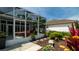 A view of a patio with garden, offering a serene outdoor living space and well-manicured landscaping at 553 Meadow Sweet Cir, Osprey, FL 34229
