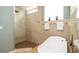 Relaxing bathroom featuring a freestanding tub, a glass-enclosed shower, and neutral tones for a spa-like experience at 553 Meadow Sweet Cir, Osprey, FL 34229