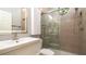 Modern bathroom features a sleek vanity, contemporary fixtures, and a glass-enclosed shower with unique circular window at 553 Meadow Sweet Cir, Osprey, FL 34229