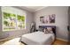 Cozy bedroom with a large window offering natural light, a comfortable bed, and stylish décor at 553 Meadow Sweet Cir, Osprey, FL 34229