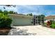 Home exterior featuring a two-car garage, well-maintained landscaping, and a screened-in patio at 553 Meadow Sweet Cir, Osprey, FL 34229