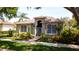 Charming single-story home with large windows, meticulous landscaping, and a secure gated entryway at 553 Meadow Sweet Cir, Osprey, FL 34229