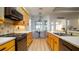 Open kitchen showcasing light wood cabinets, stone countertops, a breakfast table, and natural light through large windows at 553 Meadow Sweet Cir, Osprey, FL 34229