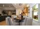 Bright kitchen connected to breakfast nook, featuring light wood cabinetry, natural stone countertops, and modern appliances at 553 Meadow Sweet Cir, Osprey, FL 34229