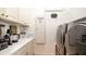 Well-equipped laundry room with modern appliances, ample counter space, and convenient storage solutions at 553 Meadow Sweet Cir, Osprey, FL 34229