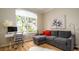 Bright living room showcasing a modern desk, comfortable seating, and a large window providing natural light at 553 Meadow Sweet Cir, Osprey, FL 34229