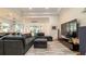 Comfortable living room with a large sectional sofa and an entertainment center at 553 Meadow Sweet Cir, Osprey, FL 34229