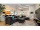 Spacious living area with a large sectional sofa, stylish rug, and views of the kitchen at 553 Meadow Sweet Cir, Osprey, FL 34229