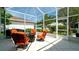 Screened patio featuring seating and a beautiful garden, perfect for outdoor relaxation and entertaining at 553 Meadow Sweet Cir, Osprey, FL 34229