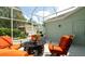 Comfortable screened-in patio with outdoor seating, a garden view, and ample natural light at 553 Meadow Sweet Cir, Osprey, FL 34229