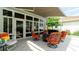Covered patio with comfortable seating, elegant table, and view of the exterior backyard at 553 Meadow Sweet Cir, Osprey, FL 34229