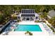 Inviting pool with sun loungers and a charming home featuring solar panels for energy efficiency at 553 Meadow Sweet Cir, Osprey, FL 34229