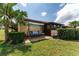 Lush backyard with patio swing, mature landscaping, and views of the rear of the home at 5709 13Th W Ave, Bradenton, FL 34209