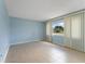 Bright bedroom with tiled flooring, neutral walls, and large window with vertical blinds at 5709 13Th W Ave, Bradenton, FL 34209