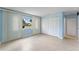 Bedroom featuring large window, tiled floors and large closet with folding doors at 5709 13Th W Ave, Bradenton, FL 34209