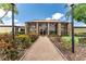 Attractive clubhouse exterior featuring a stone facade, tall windows, and a well-maintained walkway at 5709 13Th W Ave, Bradenton, FL 34209