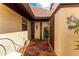 Inviting home entry with decorative rug and welcome sign, complemented by neutral-toned stucco and well-maintained exterior at 5709 13Th W Ave, Bradenton, FL 34209
