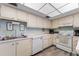 Bright kitchen featuring updated appliances, a double sink, tile flooring, and ample cabinet space at 5709 13Th W Ave, Bradenton, FL 34209