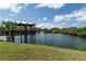 Scenic lake view featuring a charming wooden gazebo, lush greenery, and a serene fountain at 5709 13Th W Ave, Bradenton, FL 34209