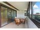 Enclosed porch with patio seating, views of the home's exterior, and sliding door entry at 5709 13Th W Ave, Bradenton, FL 34209