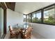 Enclosed patio with a glass table, comfortable seating, and windows at 5709 13Th W Ave, Bradenton, FL 34209