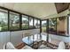 Enclosed porch with glass table and chairs; views of the exterior at 5709 13Th W Ave, Bradenton, FL 34209