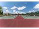Well-maintained community tennis courts with clear skies overhead at 5709 13Th W Ave, Bradenton, FL 34209