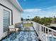 Inviting balcony with comfortable seating and views of the lush surrounding landscape at 580 Russell St, Longboat Key, FL 34228
