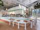 Retro bar area with a curved tile bar and many liquor bottles on display and a view to the outside at 580 Russell St, Longboat Key, FL 34228