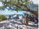 Outdoor waterfront dining with a wooden pier stretching out to the Gulf and views of boats and azure waters at 580 Russell St, Longboat Key, FL 34228
